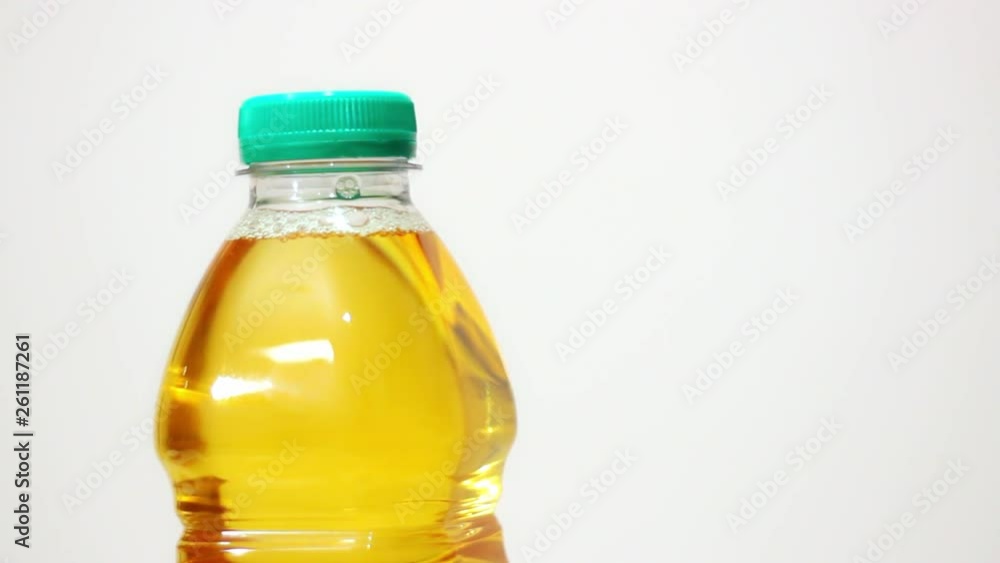 Apple juice in plastic pet bottle close-up rack focus changing. Apple juice in plastic pet bottle close-up rack focus changing.