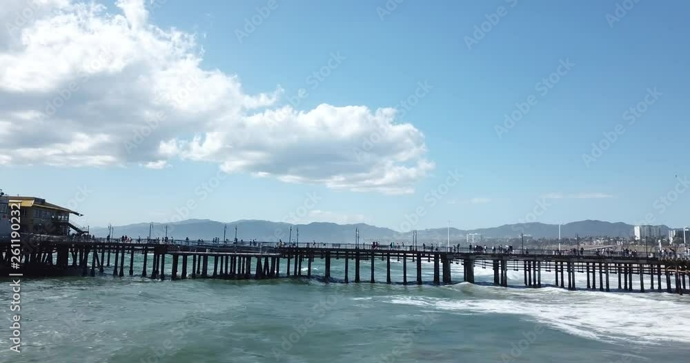 Santa Monica Pier dock with tourists and locals walking Shot from side over water in 4k at 30 frames per second.mov Santa Monica Pier dock with tourists and locals walking Shot from side over water in 4k at 30 frames per second.mov