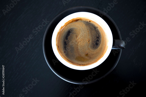 Cup of strong black coffe on wooden table