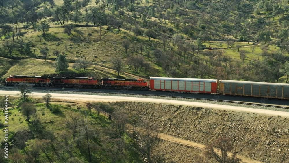 The aerial camera flies sideways following a very long freight train going south towards the Mojave Desert. The aerial camera flies sideways following a very long freight train going south towards the Mojave Desert.