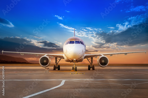 modern aircraft on an airfield against a sunset