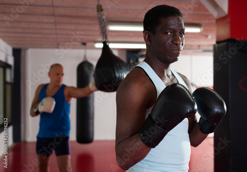 Potrait of african american boxer who is training in gym © JackF