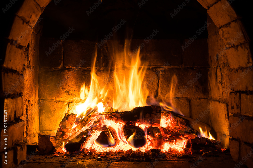 Wood burning in a cozy fireplace at home, keep warm Wood burning in a cozy fireplace at home, keep warm