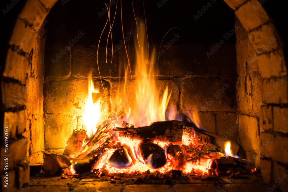 Wood burning in a cozy fireplace at home, keep warm