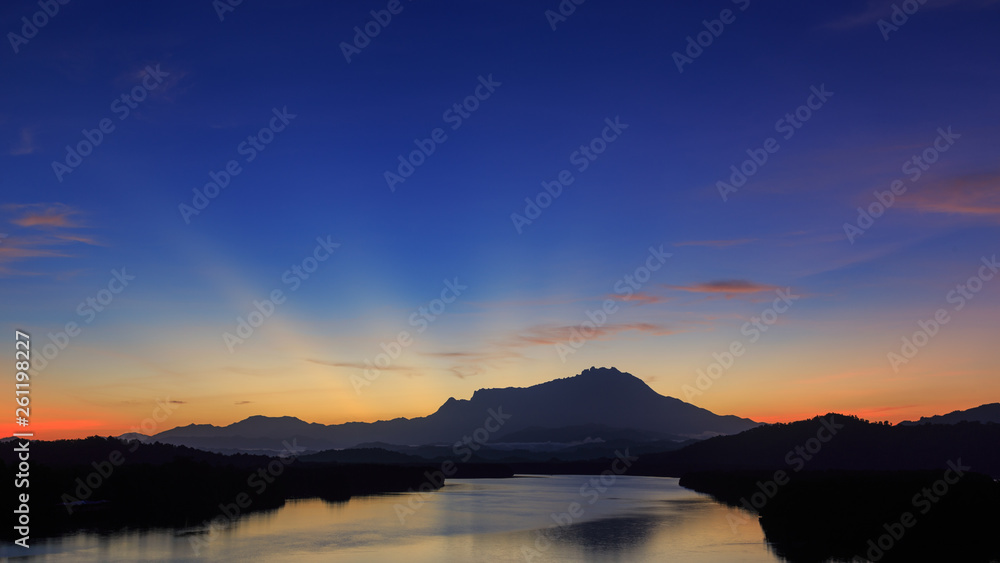 Amazing Beautiful Twilight Sunrise with Rays of light and Mount Kinabalu as background at Gayang, Tuaran, Sabah, Borneo