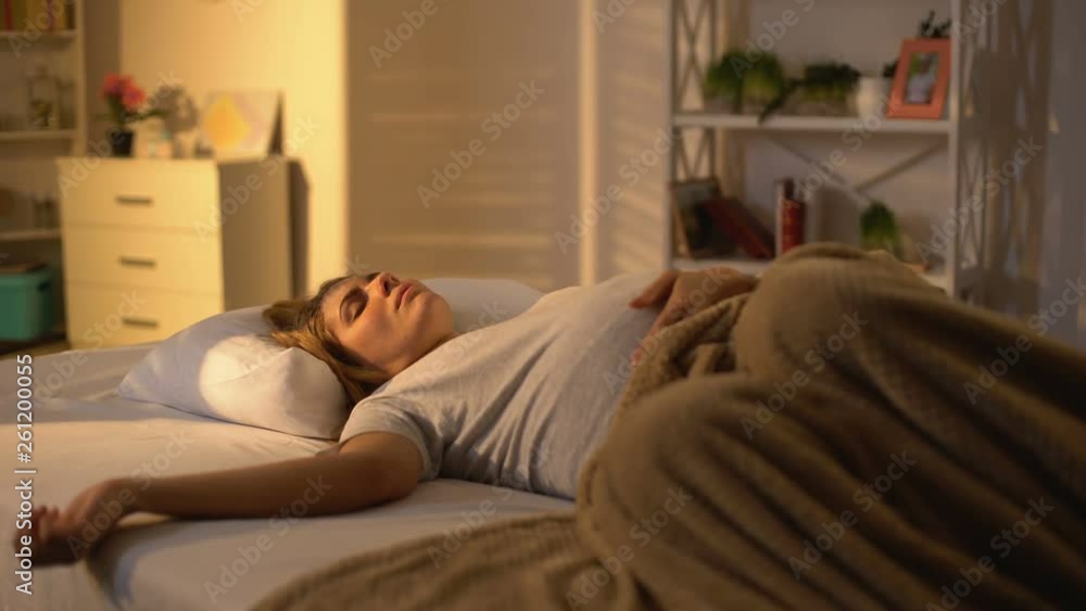 Pregnant lady sleeping in bed stroking belly, day nap, motherhood exhaustion Pregnant lady sleeping in bed stroking belly, day nap, motherhood exhaustion