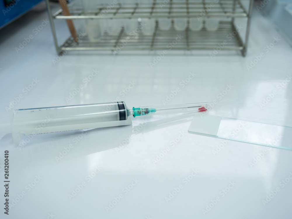 Close up doctor hand holding syringe during smear fine needle