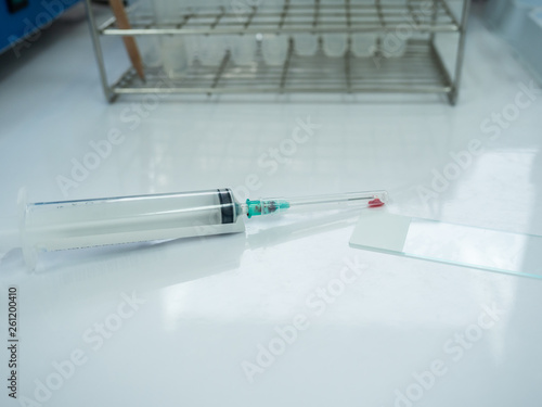 Close up doctor hand holding syringe during smear fine needle aspiration (FNA) from specimen breast.Non gynae specimen for cytology and pathology diagnosis. Medical treatment concept.