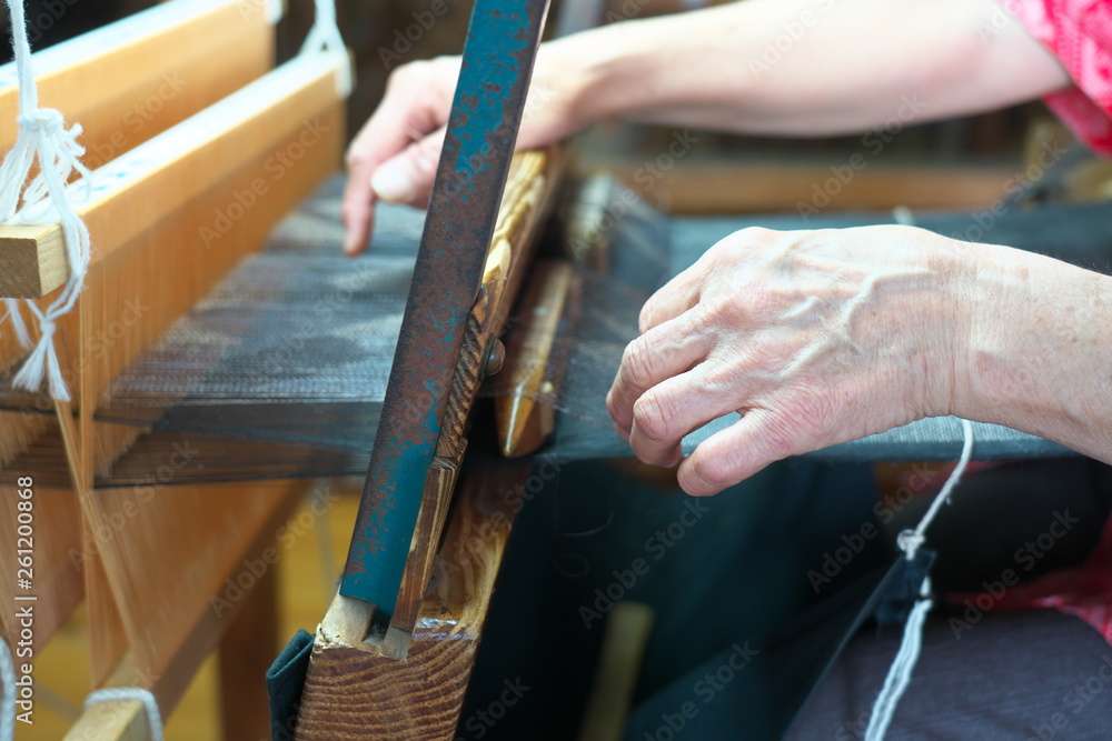 Obraz premium Amami Oshima, Japonia - 6 kwietnia 2019: Tkanie Oshimy Tsumugi z jedwabnej nici. Tradycyjne pongee w Amami Oshima.