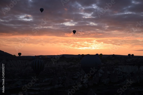 Sunrise and balloons. Beautiful background of the balloon and the sunset.Cappadocia. Turkey. Göreme. Nevşehir. Türkiye. 8. 04. 2019. Balloons flying over the rocky landscape in Cappadocia Turkey. View