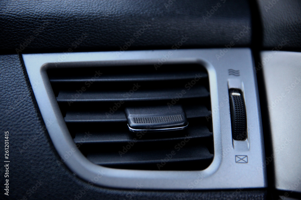 Air ducts, deflector panel with switch in the car. Car conditioner. The air flow inside the car.