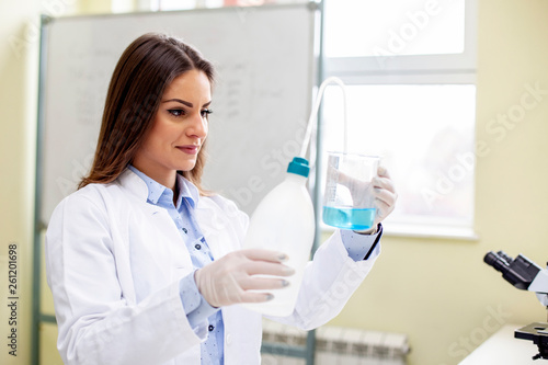 Pretty young woman working in lab