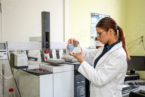 Working on chromatography with liquid woman in laboratory