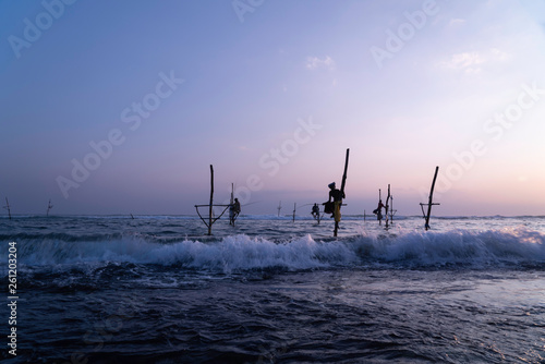 Silhouettes of the traditional fishermen at the sunset in Sri Lanka
