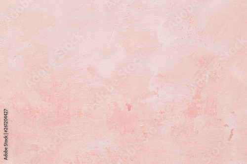Close-up of a stone or concrete wall painted in pink, paint slightly peeled off. Full frame texture background. © tuomaslehtinen