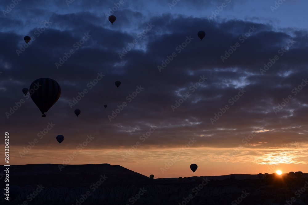 Sunrise and balloons. Beautiful background of the balloon and the sunset.Cappadocia. Turkey. Göreme. Nevşehir. Türkiye. 8. 04. 2019. Balloons flying over the rocky landscape in Cappadocia Turkey. View