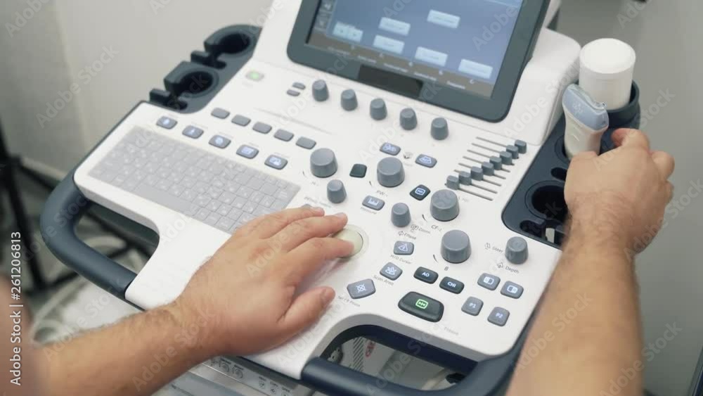 Close-up hands of doctor works on ultrasound scanner. Medical worker use special equipment. Close-up hands of doctor works on ultrasound scanner. Medical worker use special equipment.