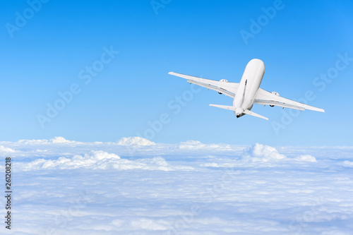 Airplane flies high in the sky on a sunny day, Vacation travel concept.