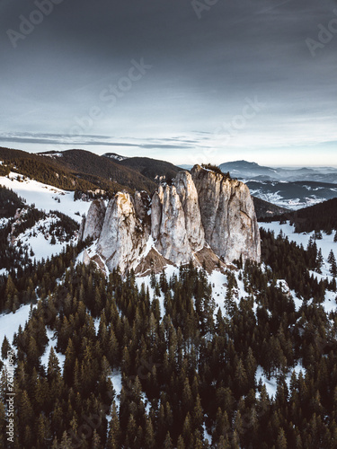 Moody Aerial View over the lonely stone in Hasmas National Park,Romania with dramatic sky at sunrise. Nature wallpaper photo