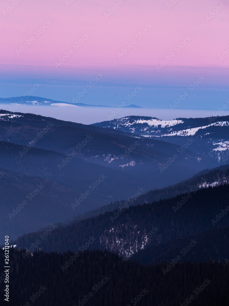 Colorful winter sunset in the Carpathian mountains.Romania,Hasmas National Park.