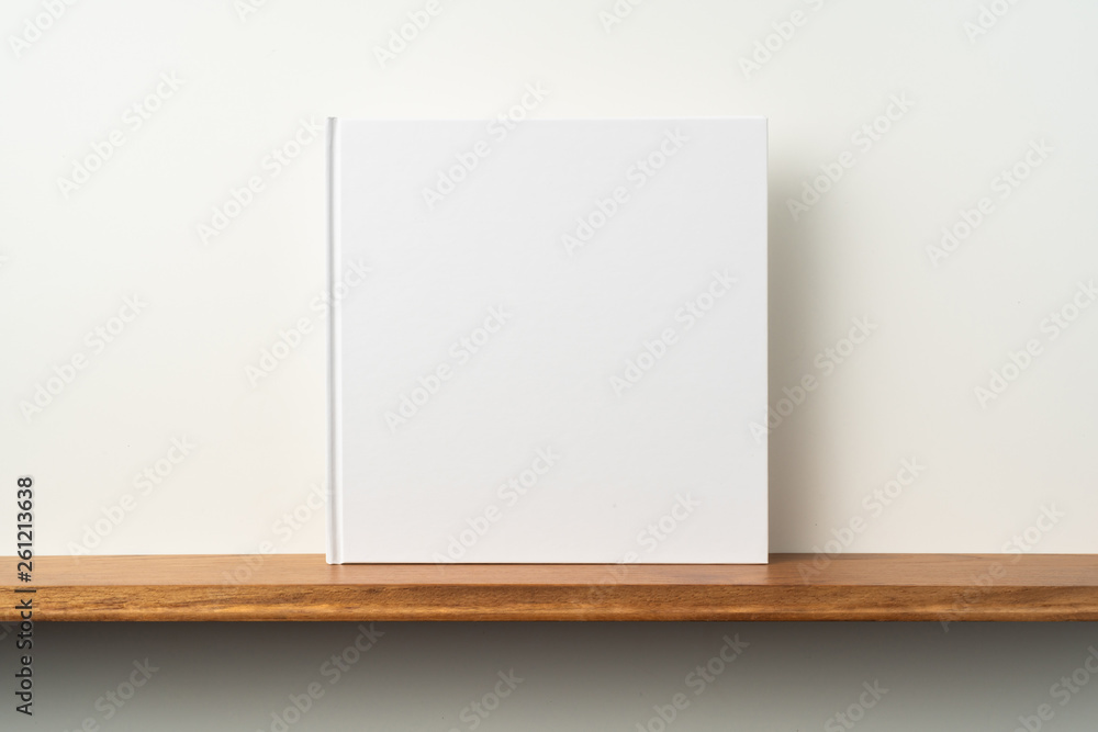 white square notebook on bookshelf and white wall white square notebook on bookshelf and white wall