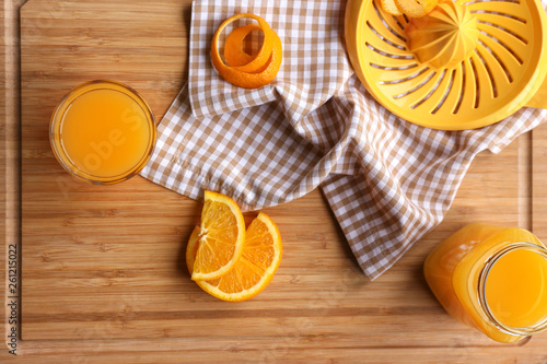 Freshly squeezed orange juice on wooden board