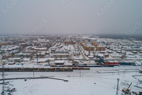 Sovetskiy city. Railway station Verkhnekondinskaya and the trains.  Aerial. Winter, snow, cloudy. Khanty Mansiysk Autonomous Okrug (HMAO), Russia. photo