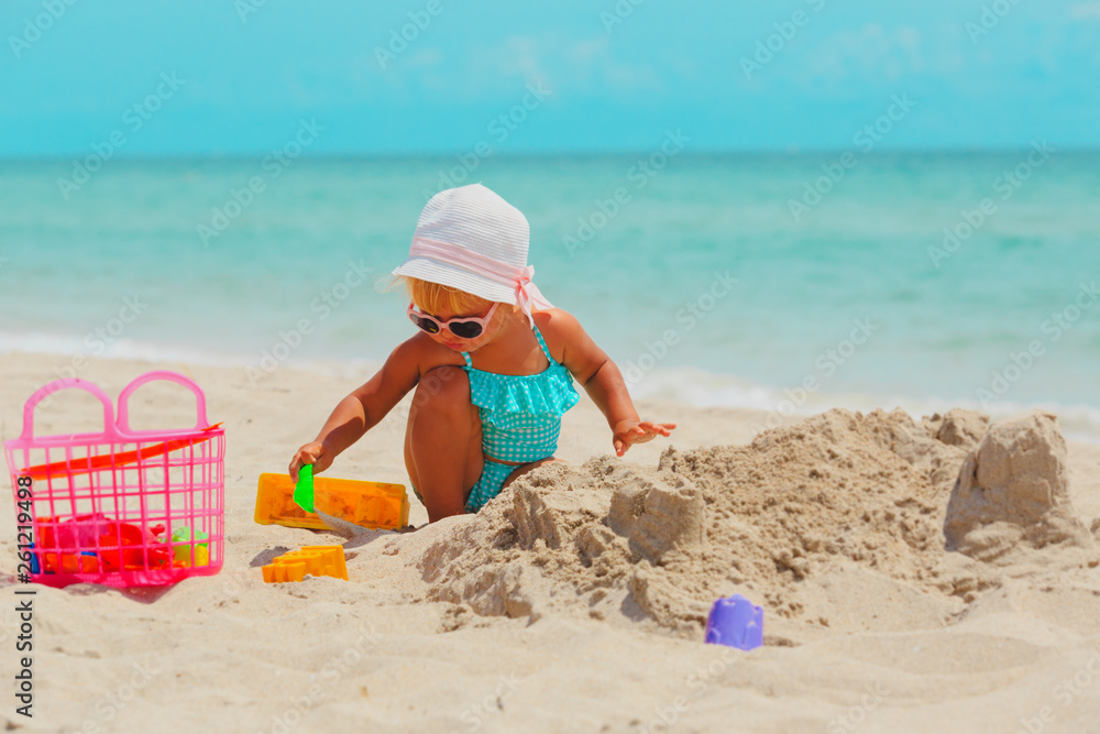 cute little girl play with sand and toys on beach cute little girl play with sand and toys on beach