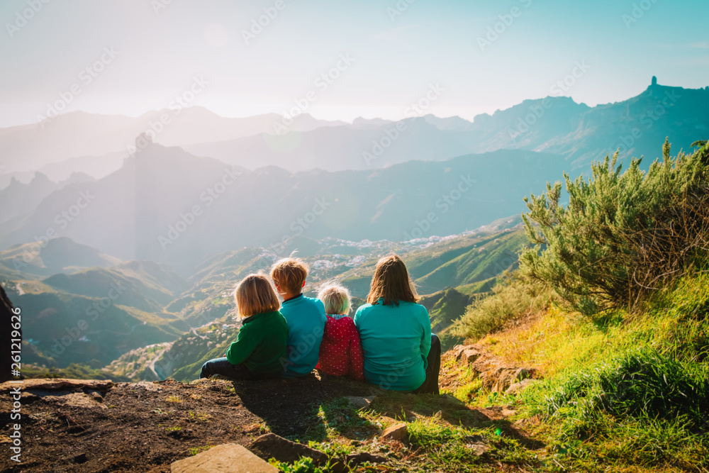 Mother with kids travel in mountains, family hiking in nature