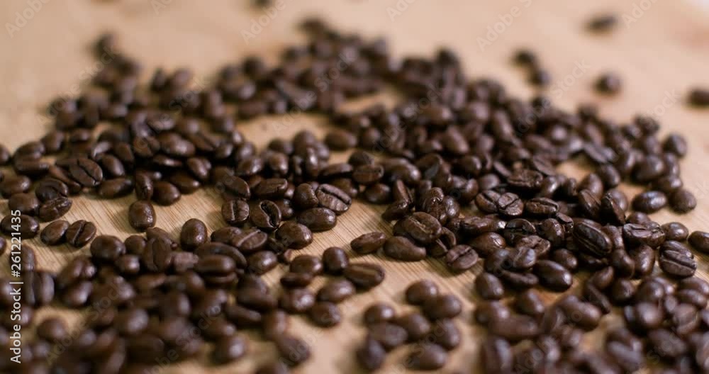 Pile of Coffee Beans on Wooden Surface Slow Fly Over 01