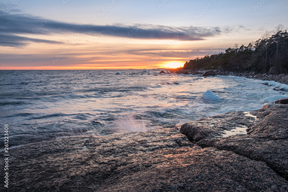 Scenic sea landscape with strong wind and sunset at winter evening in Finland coastline