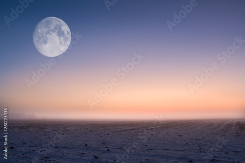 Moody moon landscape with evening light and foggy atmosphere at country field in Finland