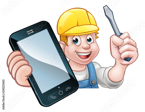 An electrician or handyman holding a screwdriver and phone with copyspace