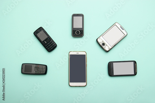 evolution of cell phones. Technology development telephone and pda concept. Vintage and new phones. Top view. Telephone communication progress, mobile classic device .