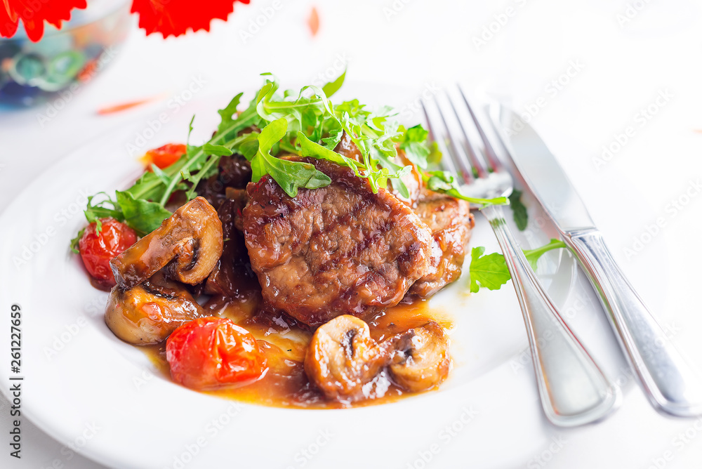 grilled beef steak and vegetables with wine and flowers on white background,