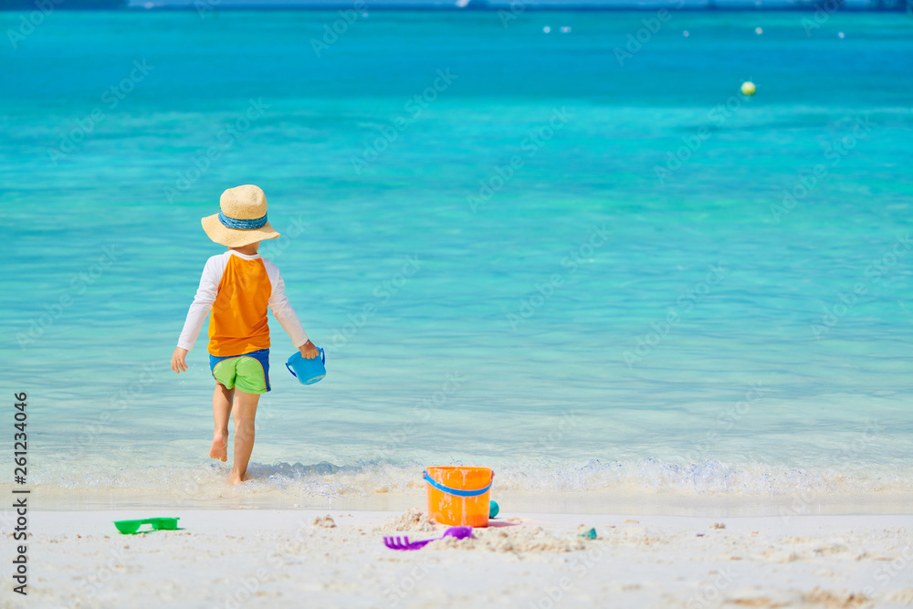 Three year old toddler playing on beach Three year old toddler playing on beach