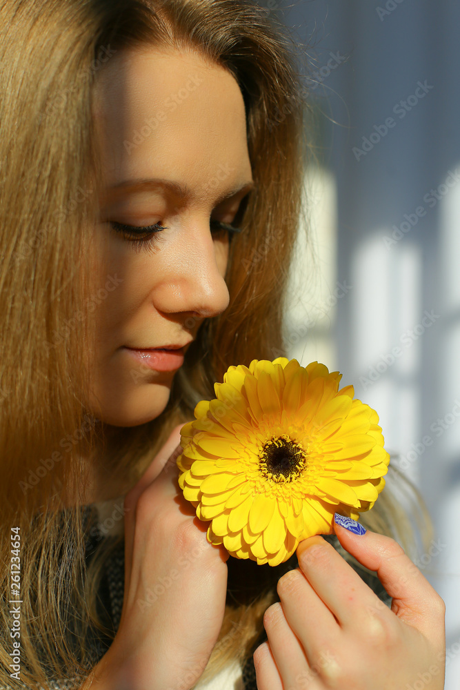 warm portrait of elegant blonde young woman with yellow gerbera warm portrait of elegant blonde young woman with yellow gerbera
