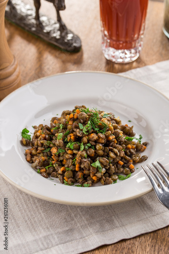 Lentil Salad with Onions, Parsley and carrot and tomato juice on wooden table