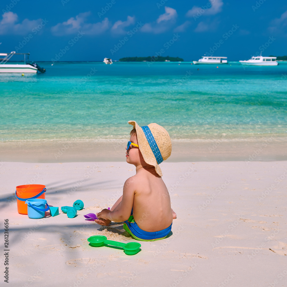 Three year old toddler playing on beach Three year old toddler playing on beach