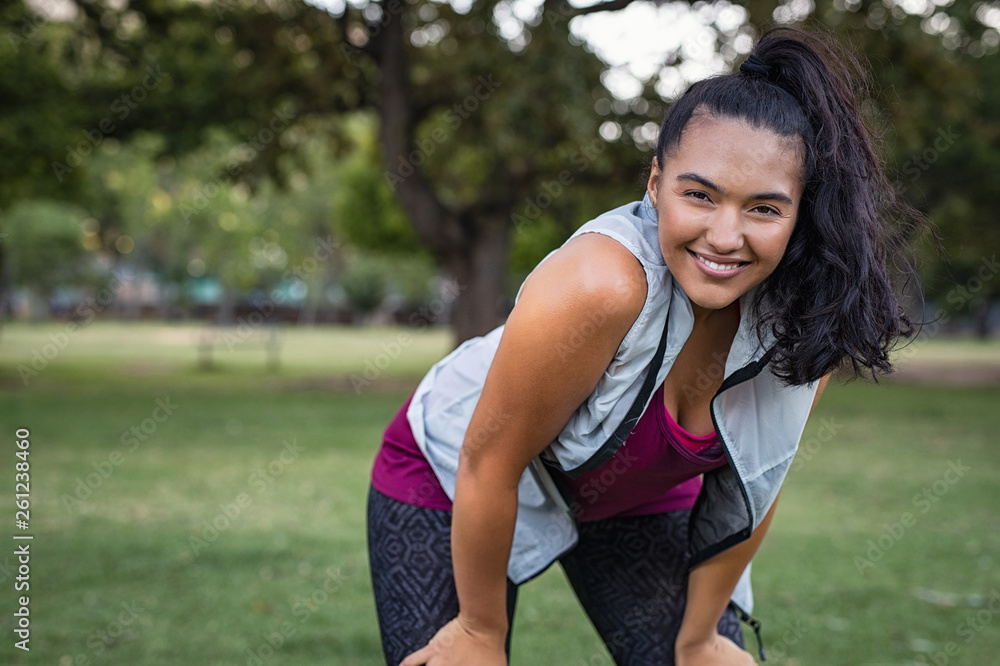 Smiling fitness woman resting after running Smiling fitness woman resting after running