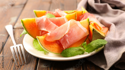 melon slices with ham and basil