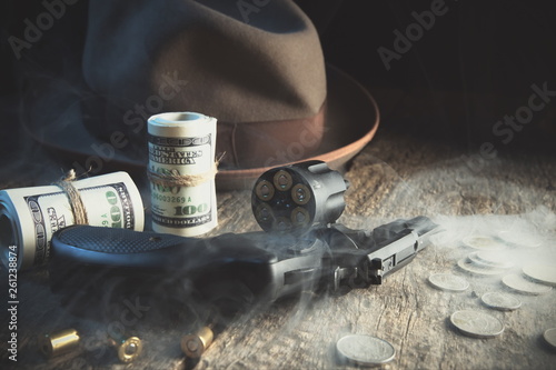Guns and money.Gangster coat,bullet,dollars .The concept of crime.Smoky background.Retro and vintage style.