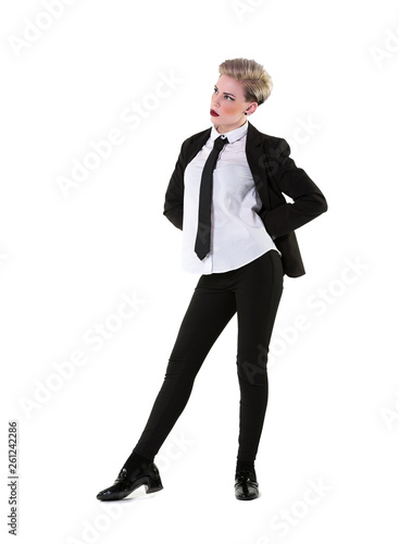 Young woman in a suit, shirt and tie, full length on white background. Blonde short hair, slim, tall and smart with some alternative attitude.