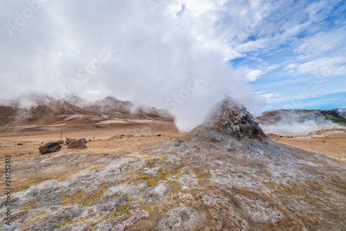 Hot spring in Hverir geothermal area with boiling mudpools and steaming fumaroles in Iceland