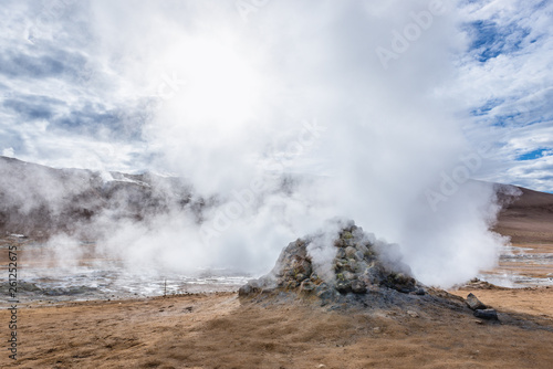 Hot spring in Hverir geothermal area with boiling mudpools and steaming fumaroles in Iceland