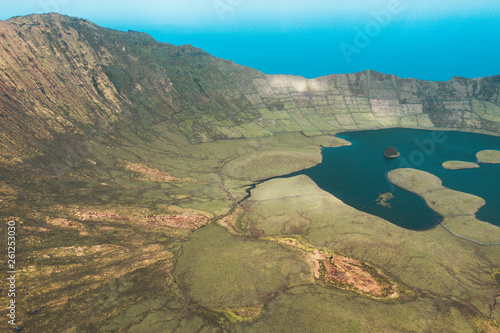 Aerial view of volcanic crater  Caldeirao  with a beautiful lake on the top of Corvo island. Azores islands  Portugal.