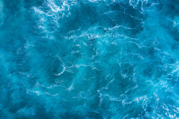 Top view of blue frothy sea surface. Shot in the open sea from above.