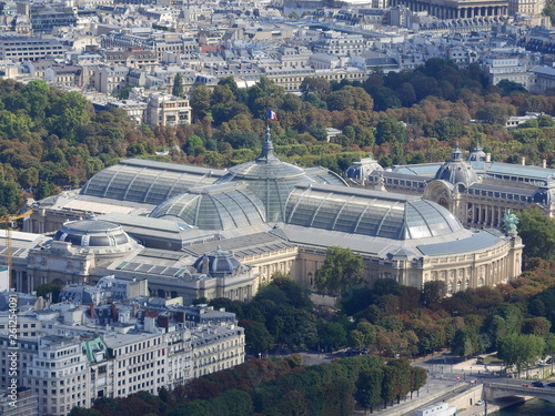 Aerial view of Paris the Grand Palais, Petit Palais and Madelaine church with tourist boats on Seine river.