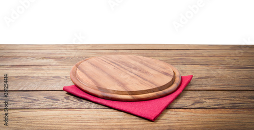 Round pizza food cutting board and table cloth red napkin on brown wooden table isolated on white background. Wood tray plate and table top view. Empty copy space. Selective focus. Banner