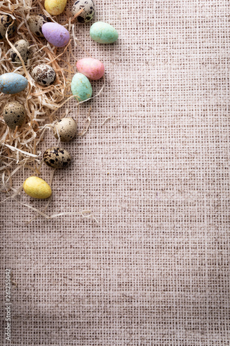 Colorful Easter, colorful quail eggs on a linen background.